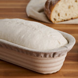 Batard banneton covered with a liner and dough inside.