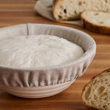 Boule banneton covered with a liner and dough inside.